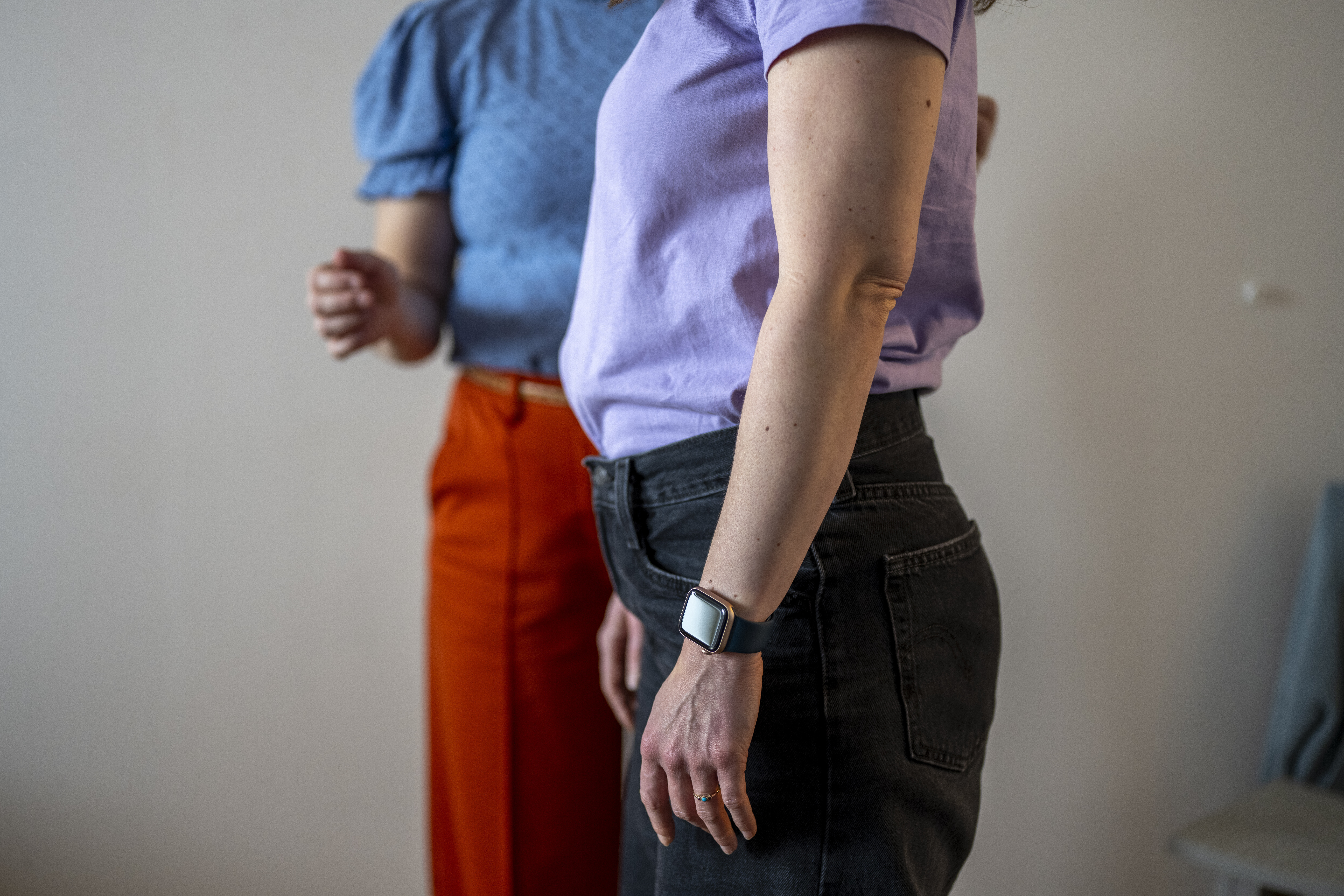 Two individuals standing side by side in casual attire.